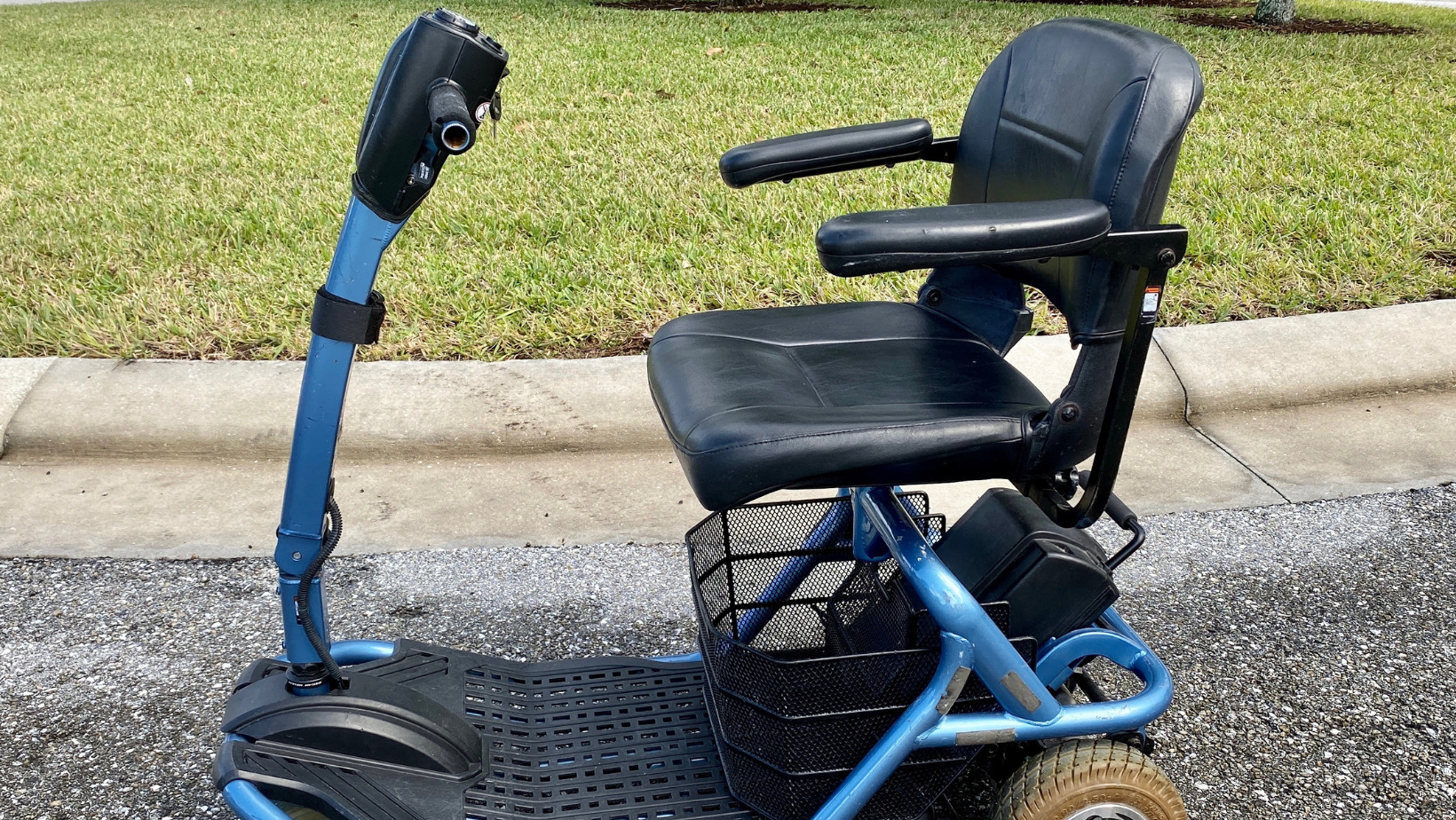 Donate a mobility aid. Scooter sitting on sidewalk.